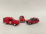 two red toy cars are sitting next to each other on a white surface