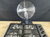 a fan that is on top of a stove