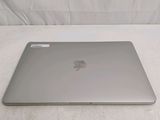 a silver apple laptop sitting on a white surface