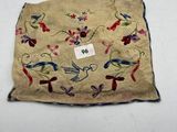 a close up of a piece of cloth with birds and flowers on it