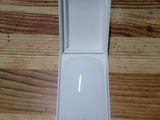 a white apple mouse in a white box on a wooden table