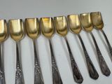 a lot of spoons that are lined up on a table
