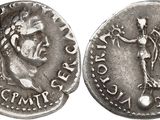 a silver coin with an image of a woman and a man on it