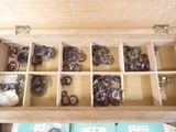 a wooden box filled with lots of different types of rings