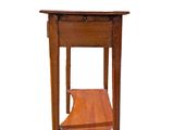 a small wooden table with a shelf on it