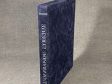 a blue book sitting on top of a table next to a white wall