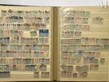 a open book with stamps on it sitting on a table
