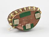 an image of a broochle with a green and brown design