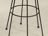 a close up of a black metal stool with a wooden seat