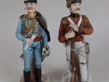 two figurines of men dressed in military uniforms