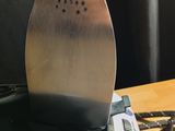 a metal iron sitting on top of a toaster on a table