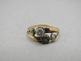 a close up of a gold and diamond ring on a table