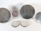 several silver objects are arranged on a white surface