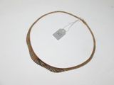 a necklace with a tag attached to it on a table
