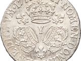 a close up of a silver coin with a crown on it