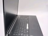 a laptop with a black keyboard on a white surface