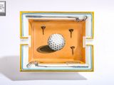 painting of a golf ball and tees in a yellow and blue ashtray
