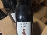 two bottles of wine that are sitting on a table