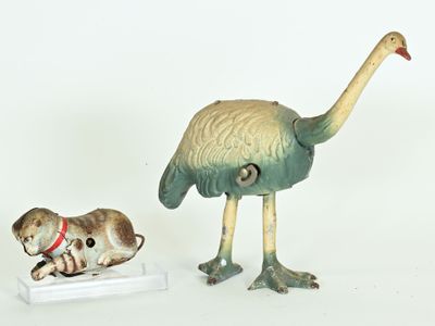 two figurines of a bird and a cat on a white surface