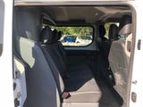 the back seats of a white van with a black seat belt