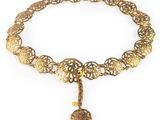 a close up of a gold necklace with a medallion on it