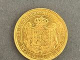 a close up of a gold coin on a gray surface