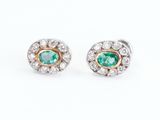 a pair of emerald and diamond earrings