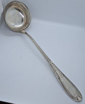 a silver spoon with a spoon handle on a plate