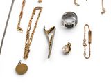 many different types of necklaces and rings on a white surface