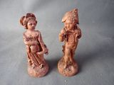 two figurines that are sitting next to each other