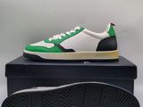 a close up of a pair of green and white sneakers on top of a box