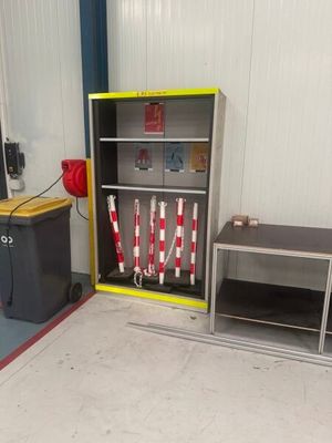 a fire hydrant in the middle of a room next to a bookcase