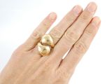 a woman ' s hand with a gold ring on it