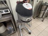 a machine that is sitting in a kitchen next to a stove