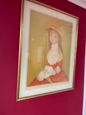 a picture of a woman in a red dress hanging on a wall