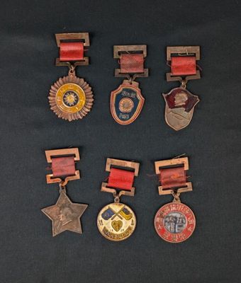 several medals are displayed on a black surface with a black background