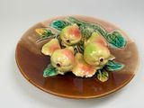 a brown plate with a bunch of fruit on it