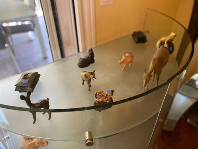 a glass table with a lot of animal figurines on it