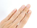 a woman ' s hand with a diamond ring on it