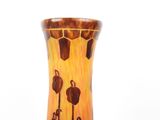 a vase that is sitting on a table in front of a white background