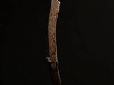 a knife on a stand against a black background
