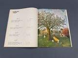 an open book with a picture of a tree in it
