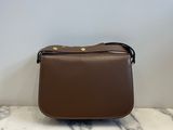 a brown purse sitting on top of a marble counter top