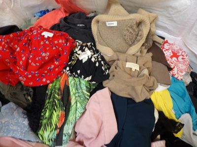 a pile of clothes that is sitting on the floor