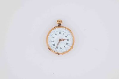 a gold pocket watch with roman numerals on the face
