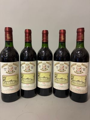 six bottles of wine are lined up on a table