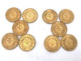 six different types of gold coins on a white surface