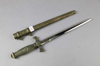 a knife that is laying on a table next to another knife