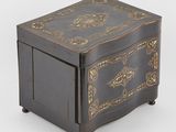 a black wooden box with gold decoration on the lid
