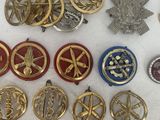 some of the medals are laying out on a white surface